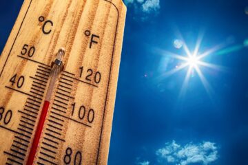 Thermometer die 40 graden aangeeft met de zon op de achtergrond